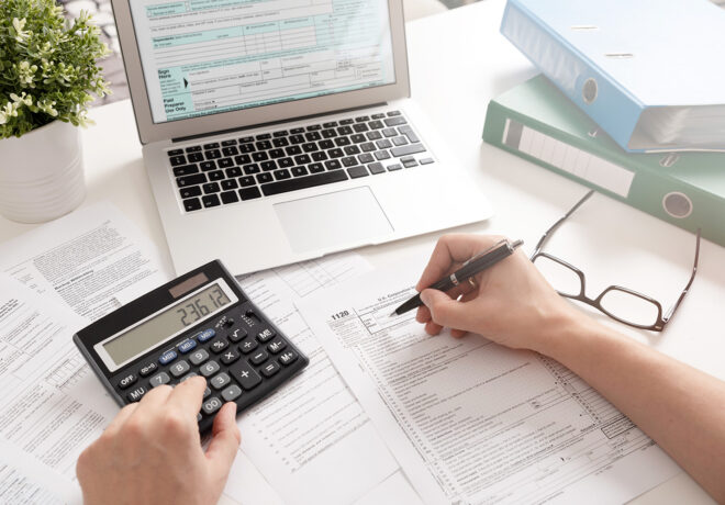 Accountant working with US tax forms US Individual income tax return. Accountant working with US tax forms